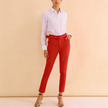 Red high-waist pants with grommet belt, slim ankle-length silhouette