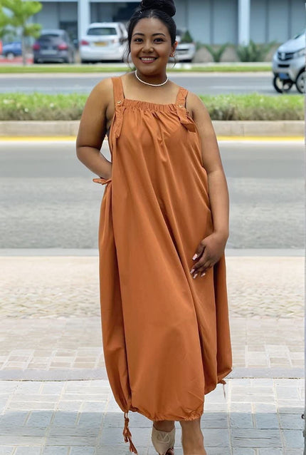 Orange utility maxi dress with square neckline, gathered bust, and drawstring ties