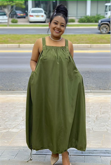 Army-green utility maxi dress with adjustable drawstring straps and bib neckline