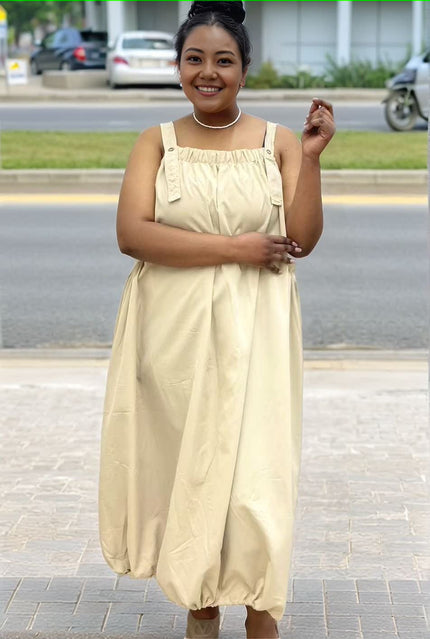 Light-beige utility maxi dress with square neckline, side ties, and roomy maxi skirt