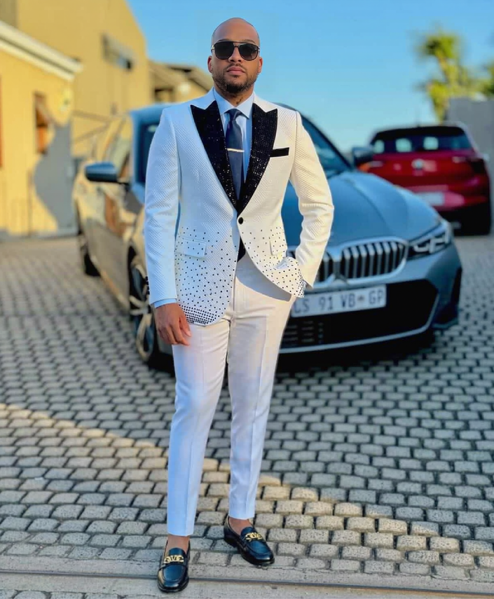White tuxedo suit with rhinestone shawl lapels, black glitter trim and matching trousers