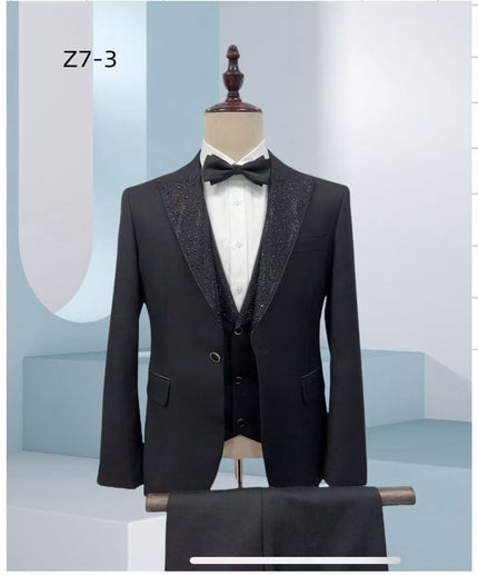 Black rhinestone tuxedo suit with notch lapels, black bow tie, and white dress shirt